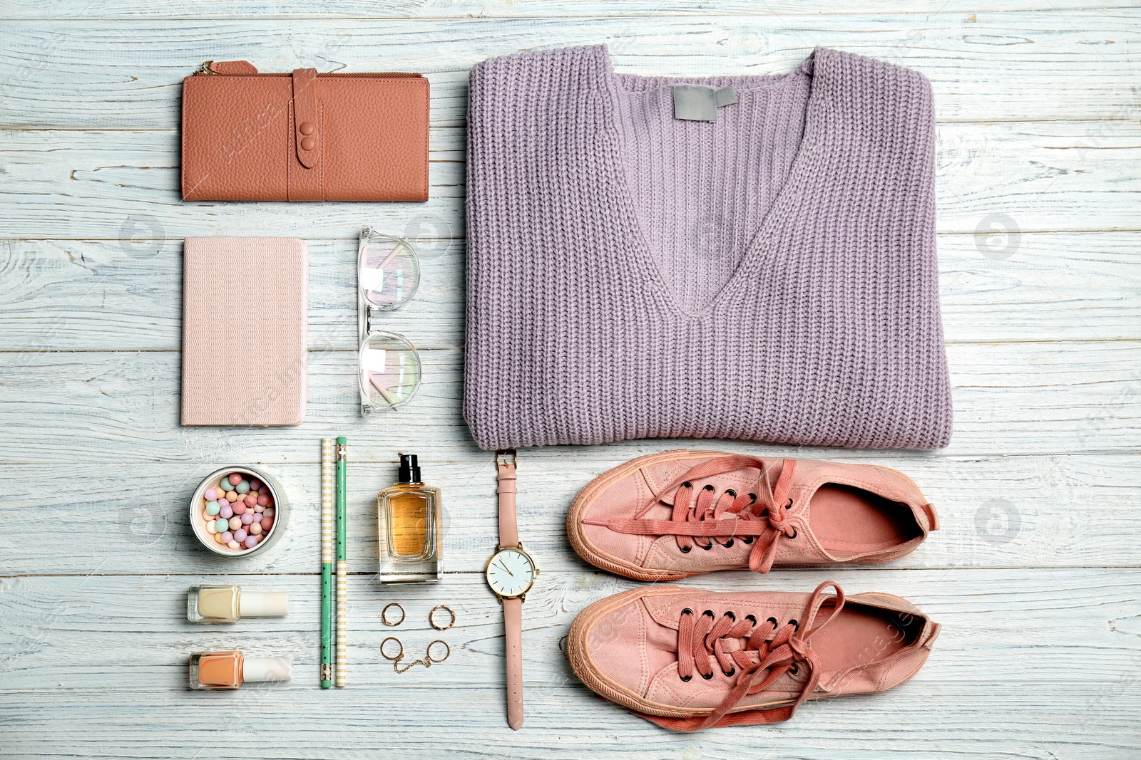 Photo of Flat lay composition with clothes, cosmetics and stylish accessories on light background