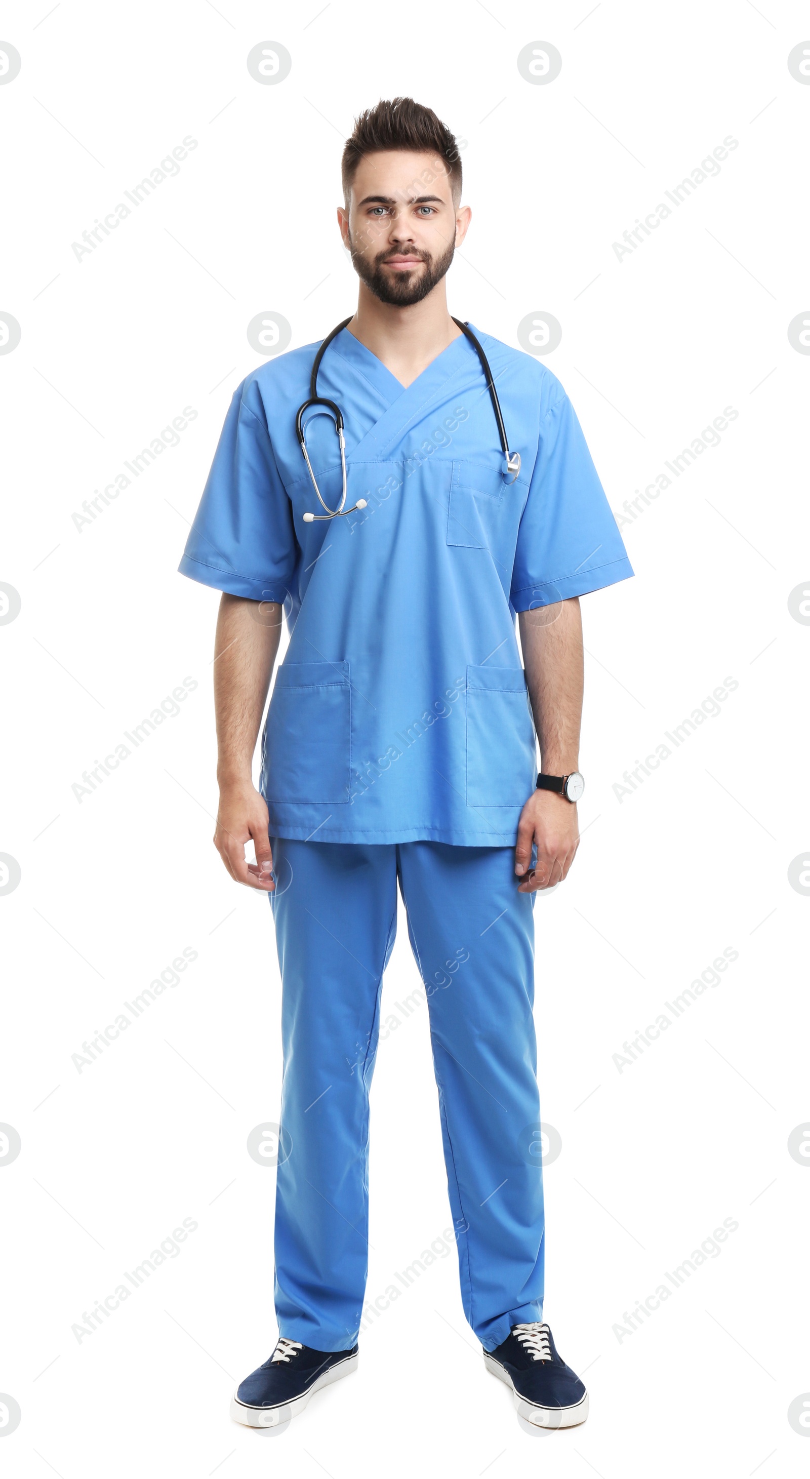 Photo of Young male doctor in uniform isolated on white