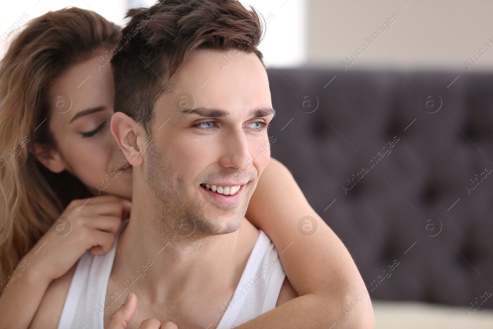 Photo of Happy young couple hugging indoors