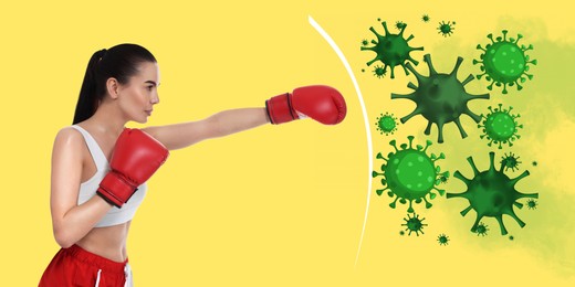 Sporty woman with boxing gloves exercising on yellow background, banner design. Strong immunity helping fight with viruses