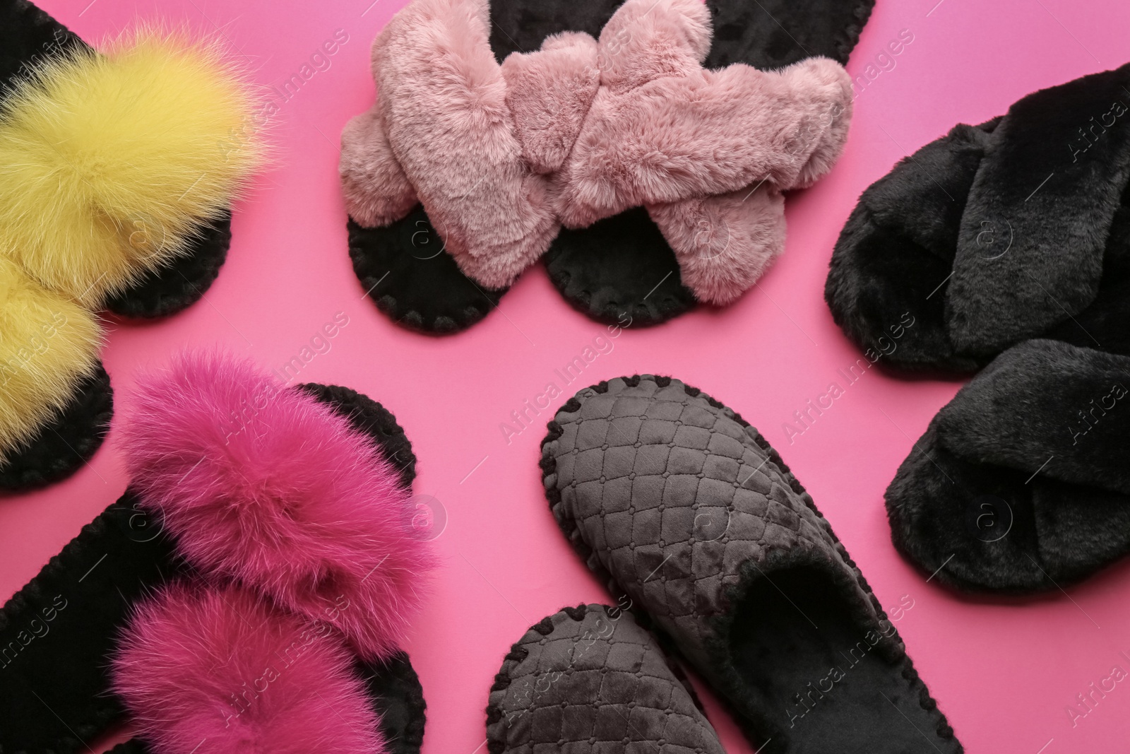 Photo of Different soft slippers on pink background, flat lay