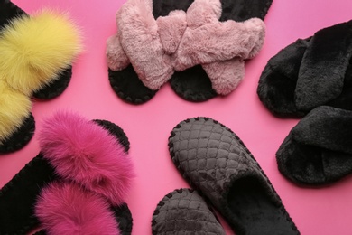 Photo of Different soft slippers on pink background, flat lay