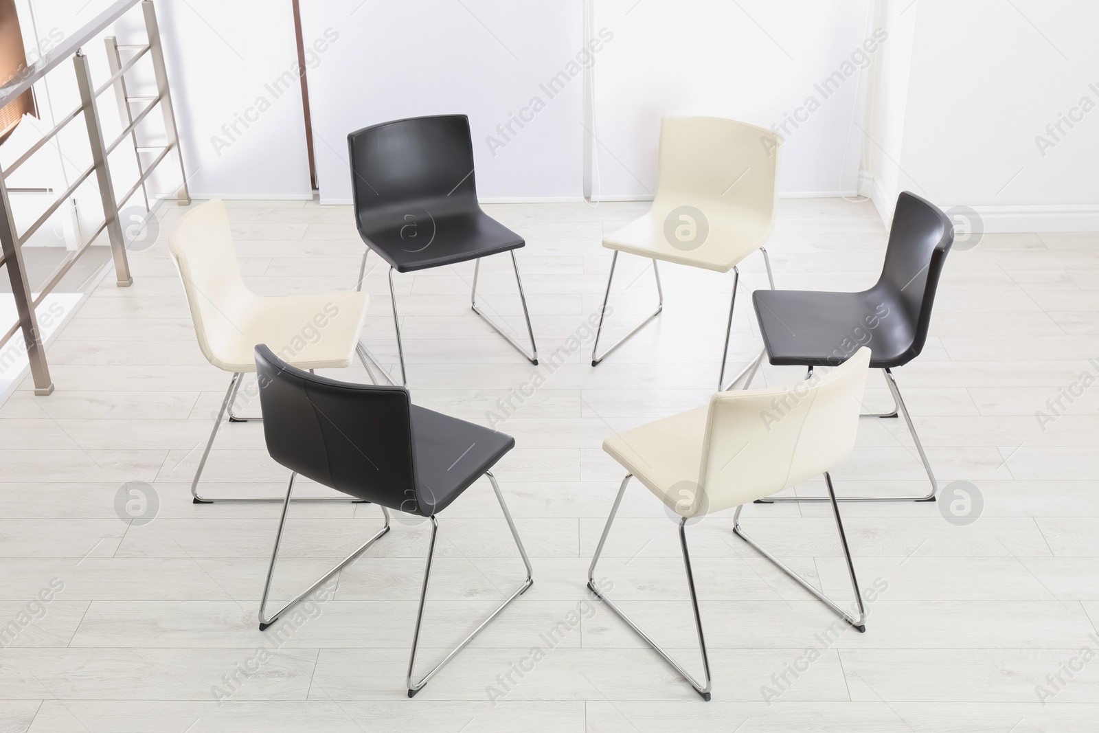 Photo of Empty chairs prepared for group psychotherapy session indoors