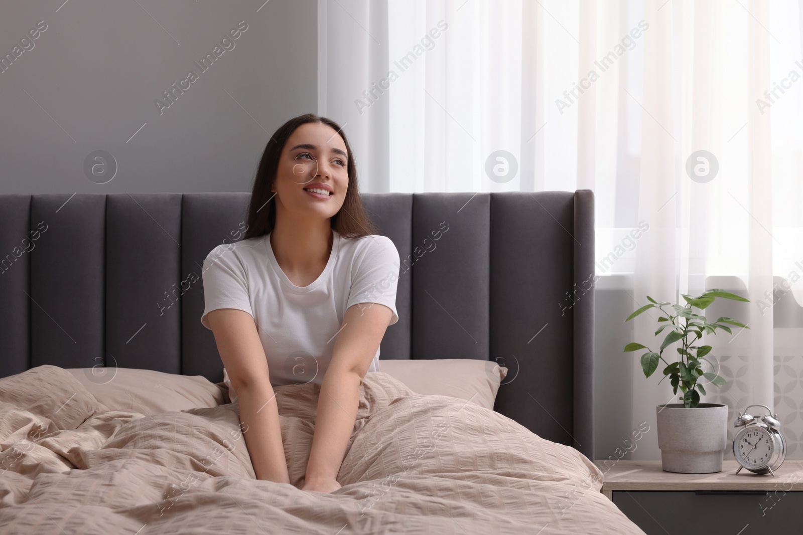 Photo of Beautiful woman in bed at home. Lazy morning