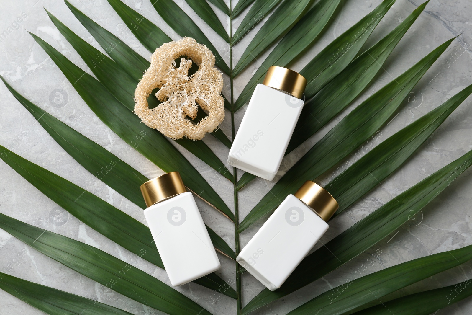 Photo of Flat lay composition with jars for cosmetic products on stone table. Spa supplies