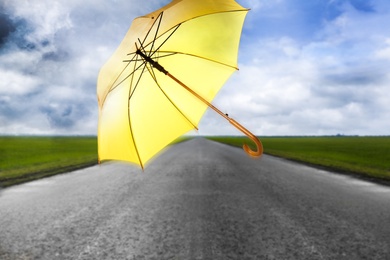 Image of Open umbrella blown by wind gust outdoors