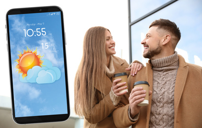 Image of Lovely couple on city street and smartphone with open weather forecast app 