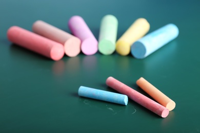 Color pieces of chalk on table, closeup
