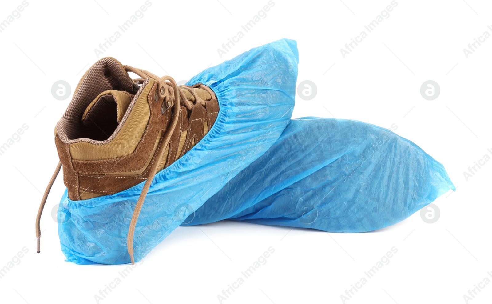 Photo of Boots in blue shoe covers isolated on white