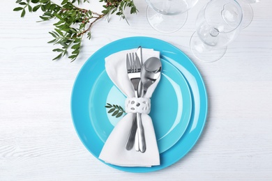 Photo of Festive table setting with plates, cutlery and napkin on wooden background, flat lay
