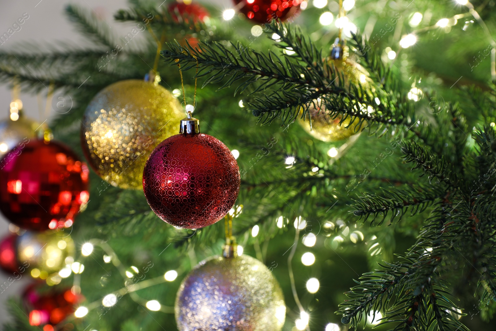 Photo of Beautifully decorated Christmas tree with baubles, closeup