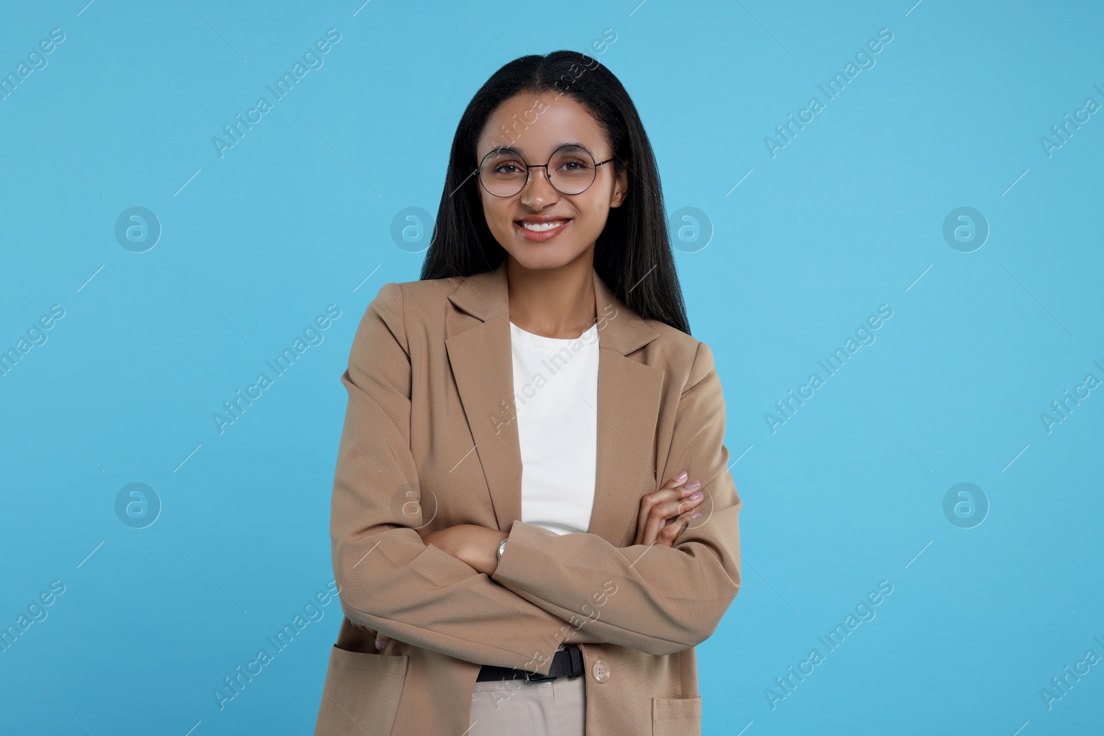 Photo of Portrait of beautiful secretary on light blue background