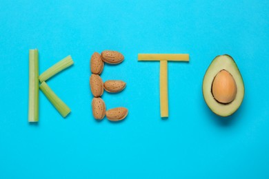 Word Keto made with different products on light blue background, flat lay