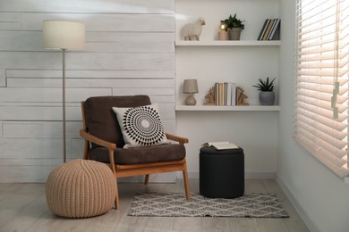 Photo of Stylish comfortable poufs near armchair in room. Home design