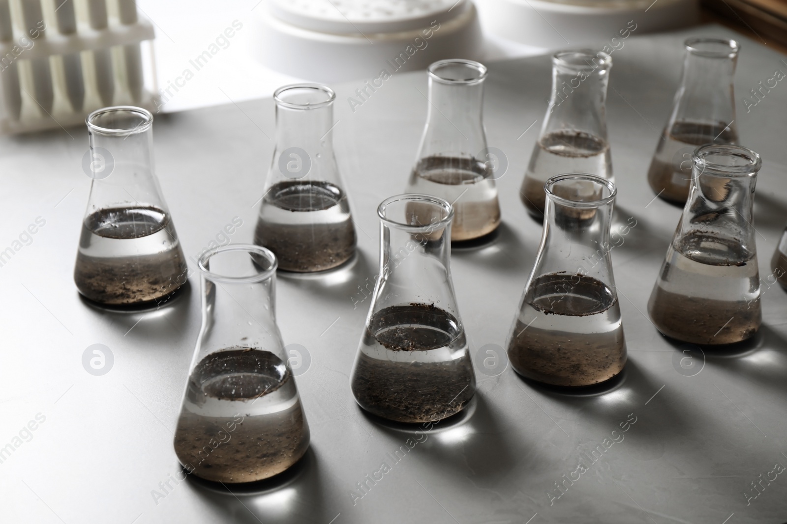 Photo of Laboratory glassware with soil extracts on table