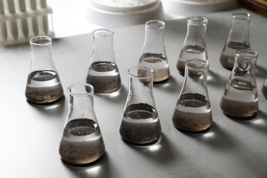 Laboratory glassware with soil extracts on table