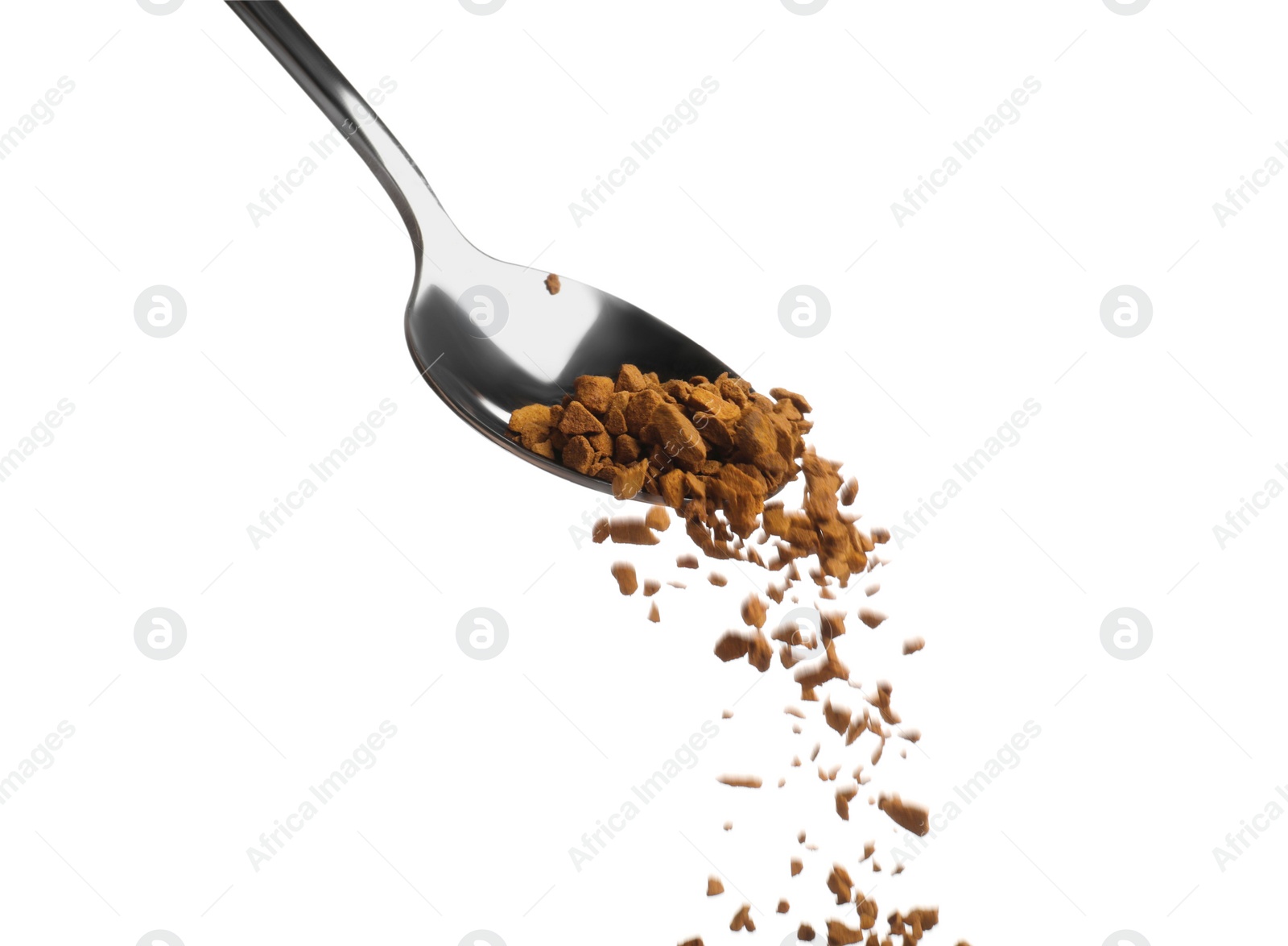 Photo of Pouring aromatic instant coffee from spoon on white background