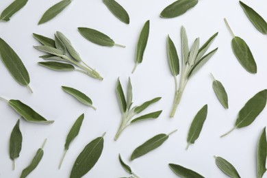Photo of Fresh green sage leaves on light background, flat lay