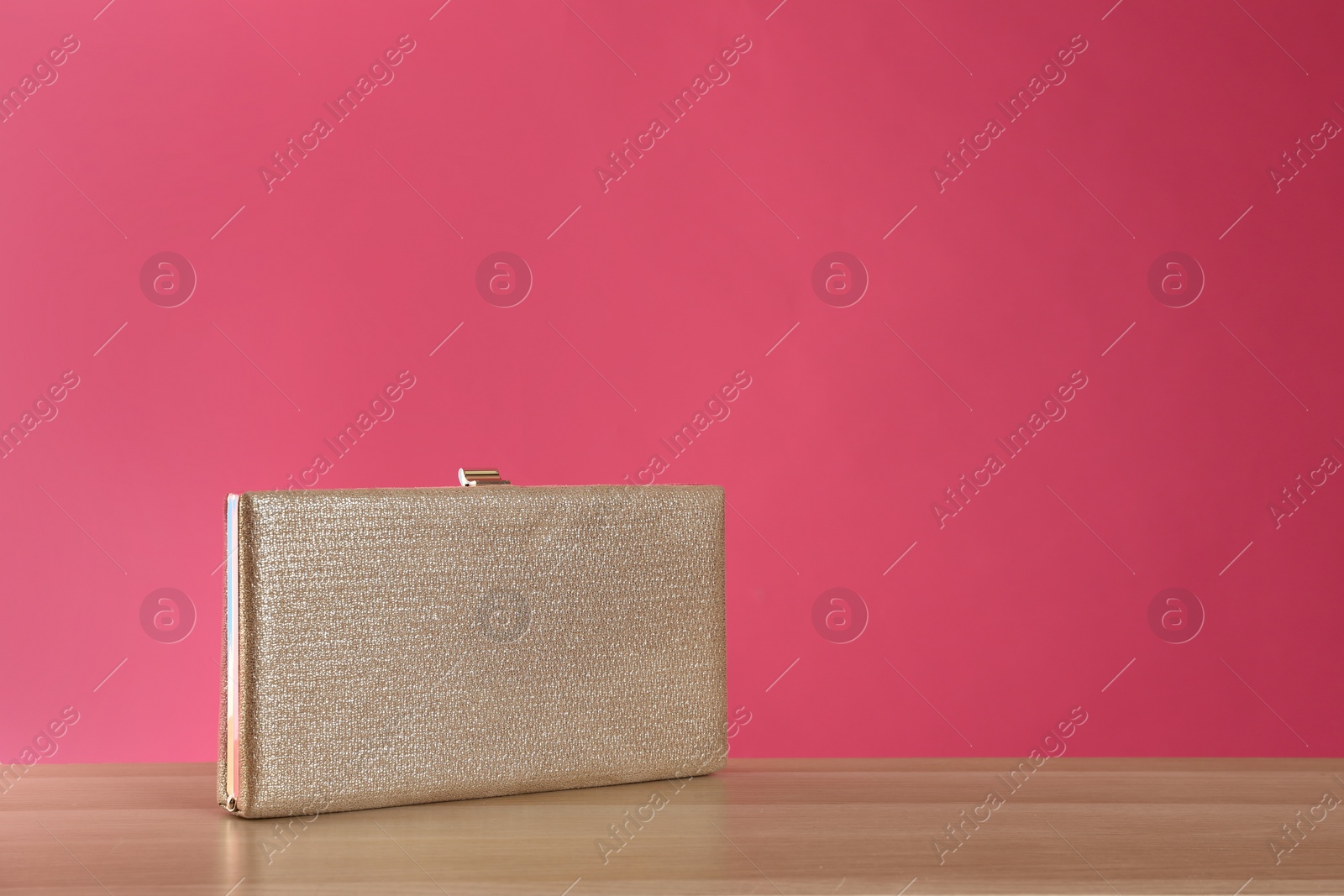 Photo of Stylish woman's purse on wooden table. Space for text