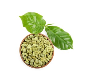 Photo of Wooden bowl with green coffee beans and fresh leaves on white background, top view