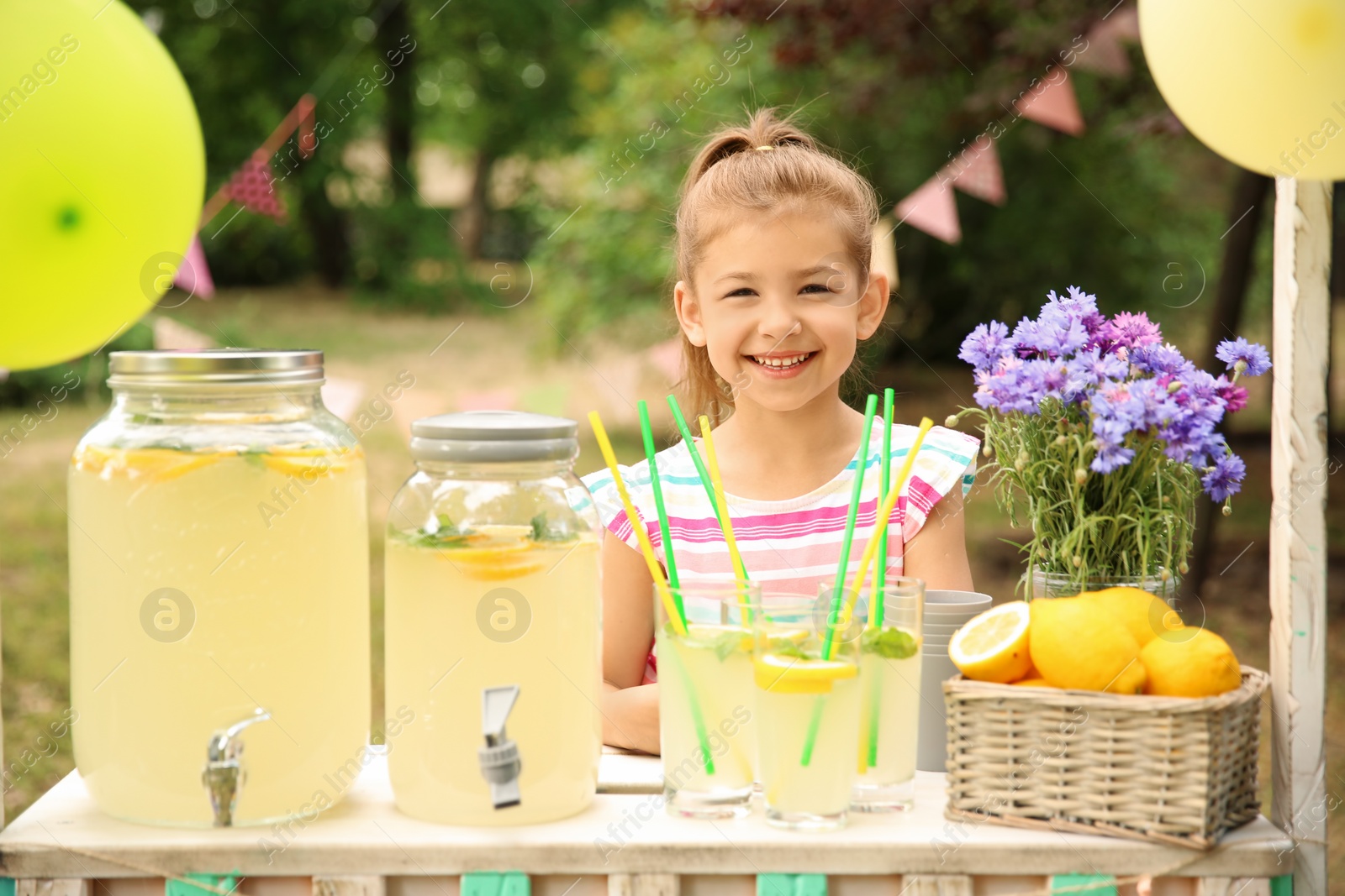 Photo of Little girl at lemonade stand in park