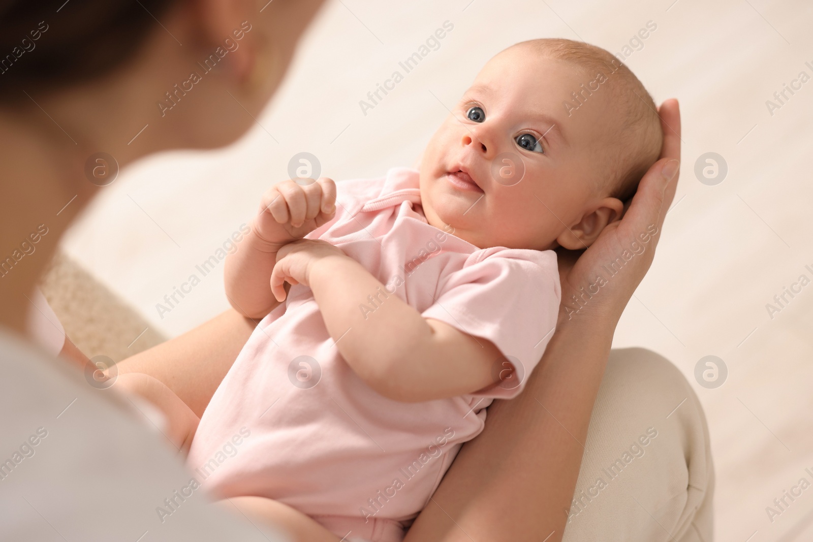 Photo of Mother with her cute little baby at home