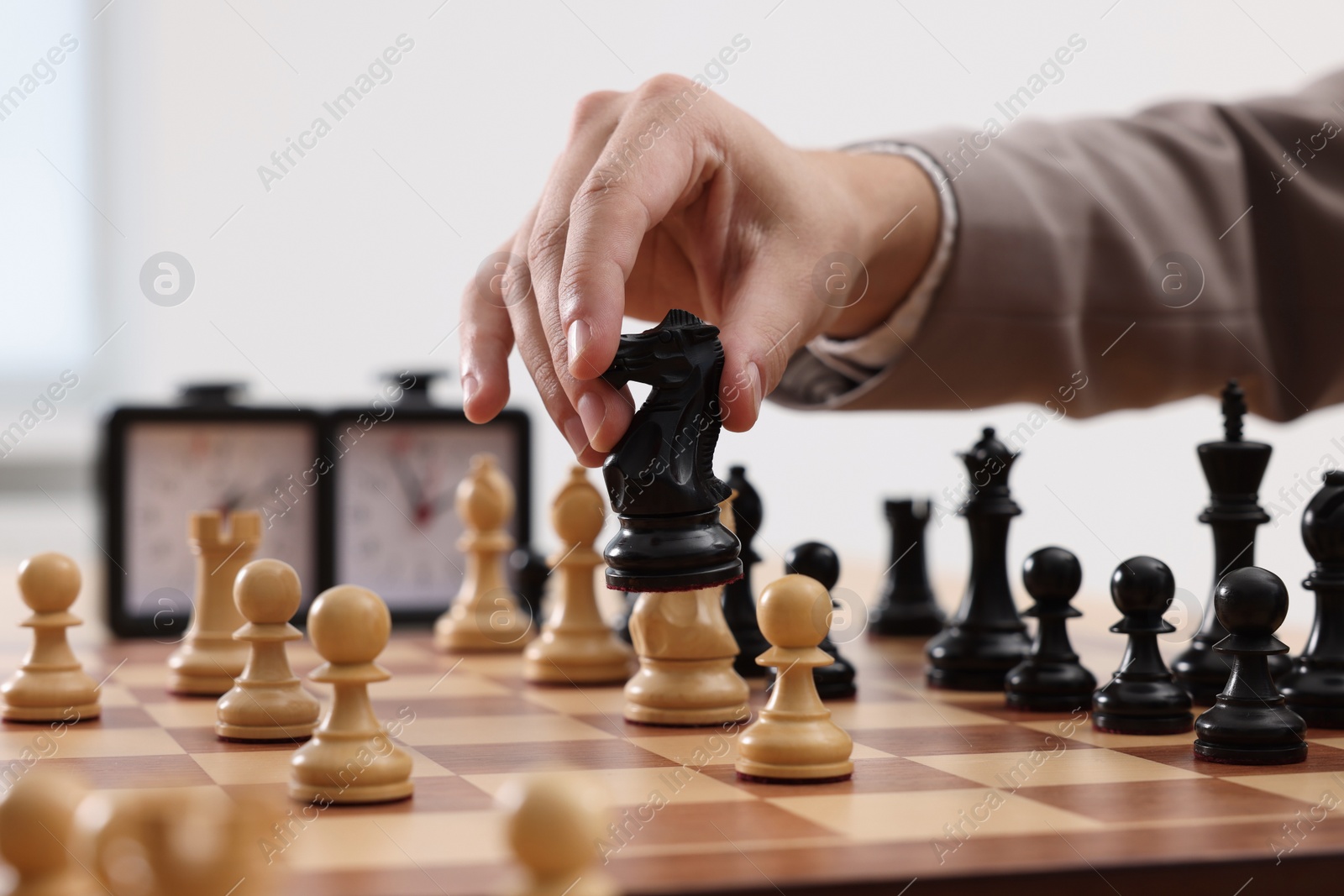 Photo of Man playing chess during tournament at chessboard, closeup