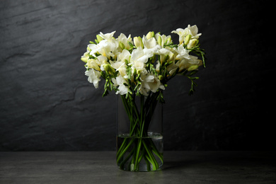 Photo of Beautiful white freesia flowers on black background