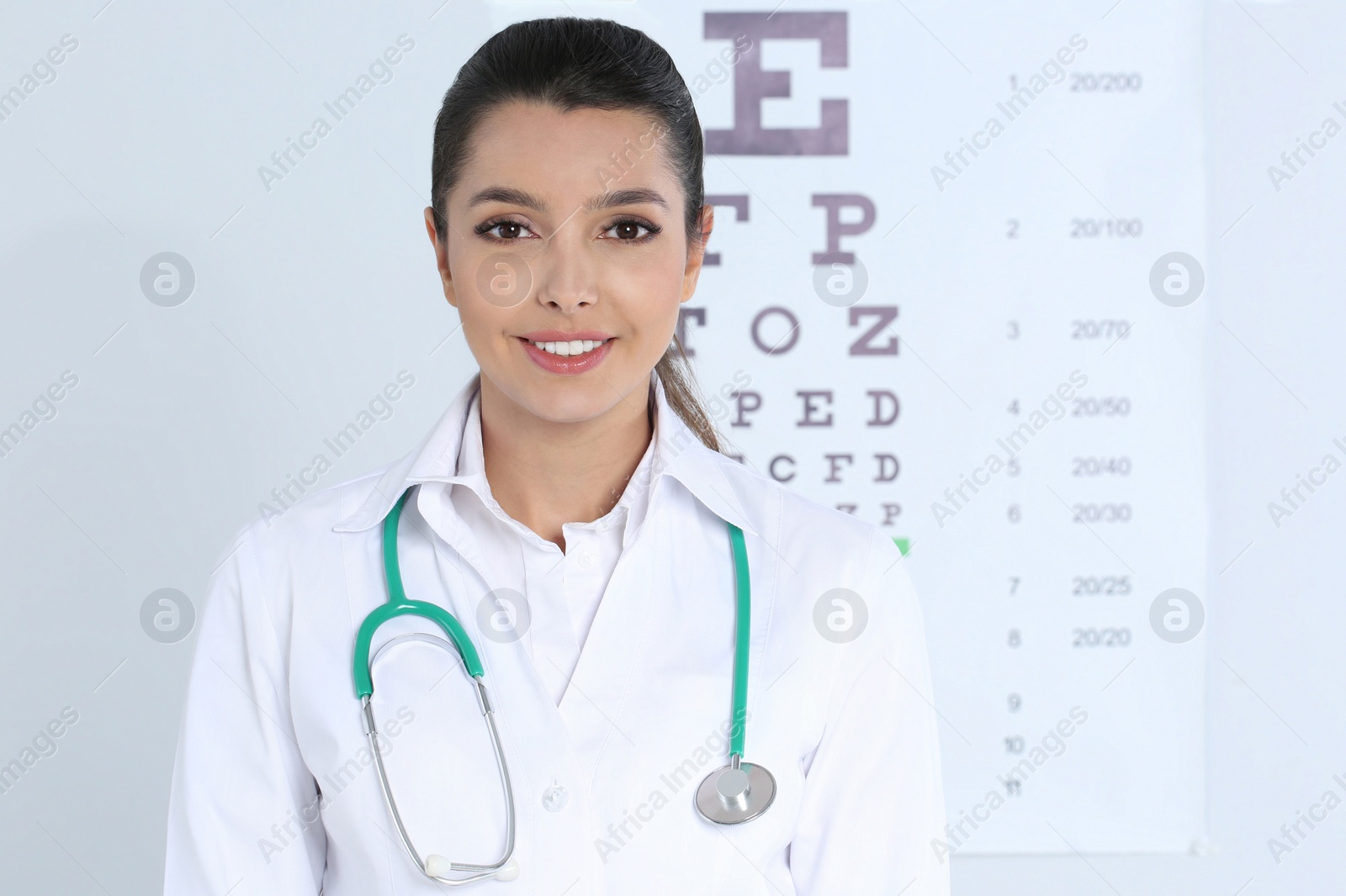 Photo of Female children's doctor near eye chart in hospital