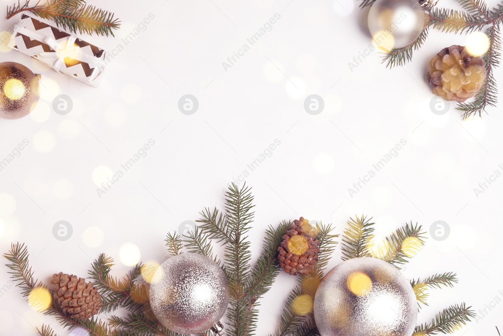 Photo of Christmas greeting card with space for text. Flat lay composition of fir tree branches and festive decor on white background