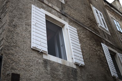 Photo of Beautiful old building with stone wall and windows