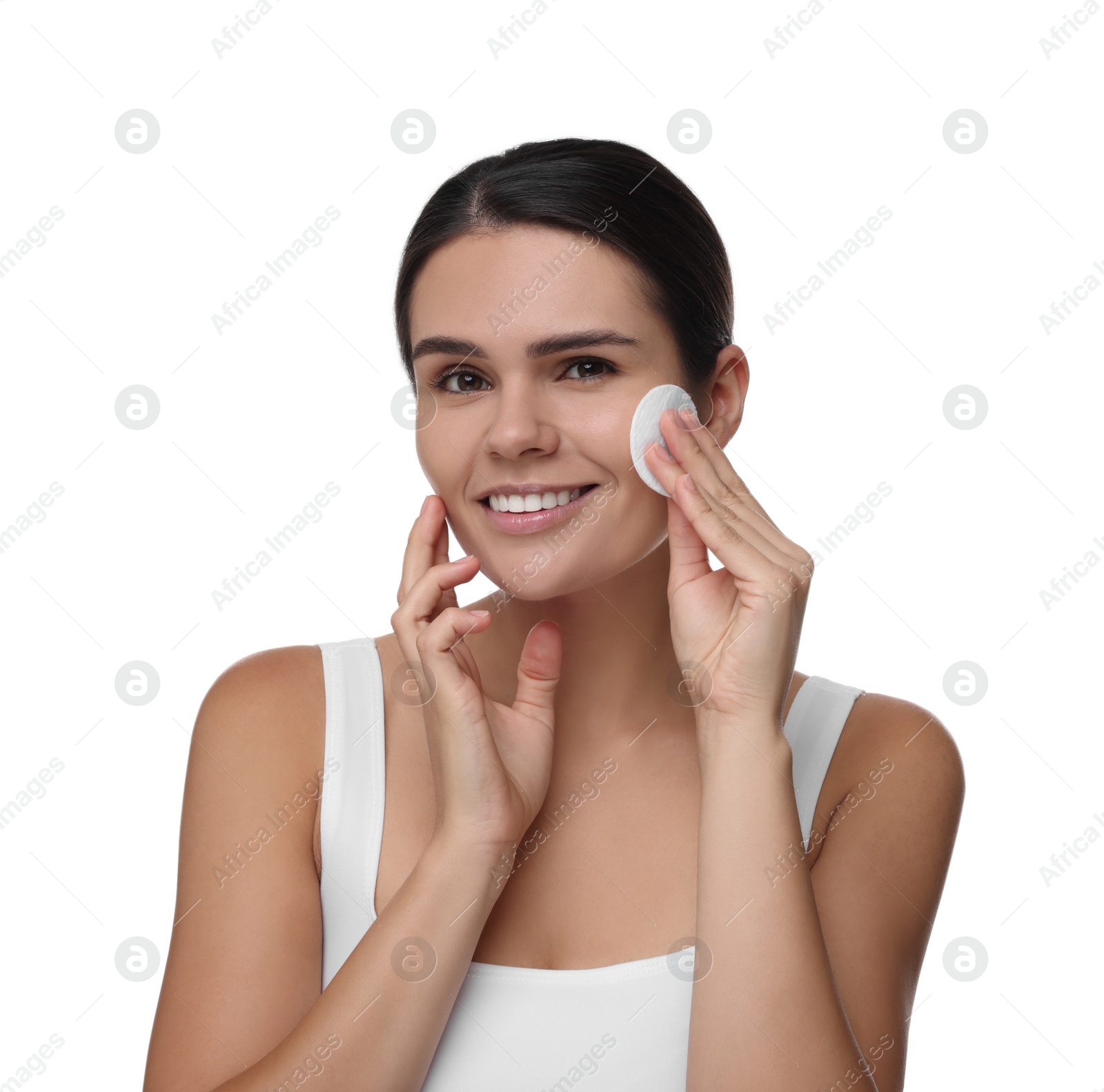 Photo of Young woman cleaning her face with cotton pad on white background