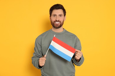 Man with flag of Netherlands on yellow background