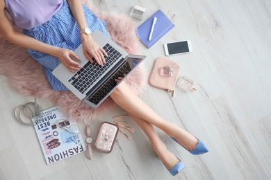 Female beauty blogger with laptop indoors, top view