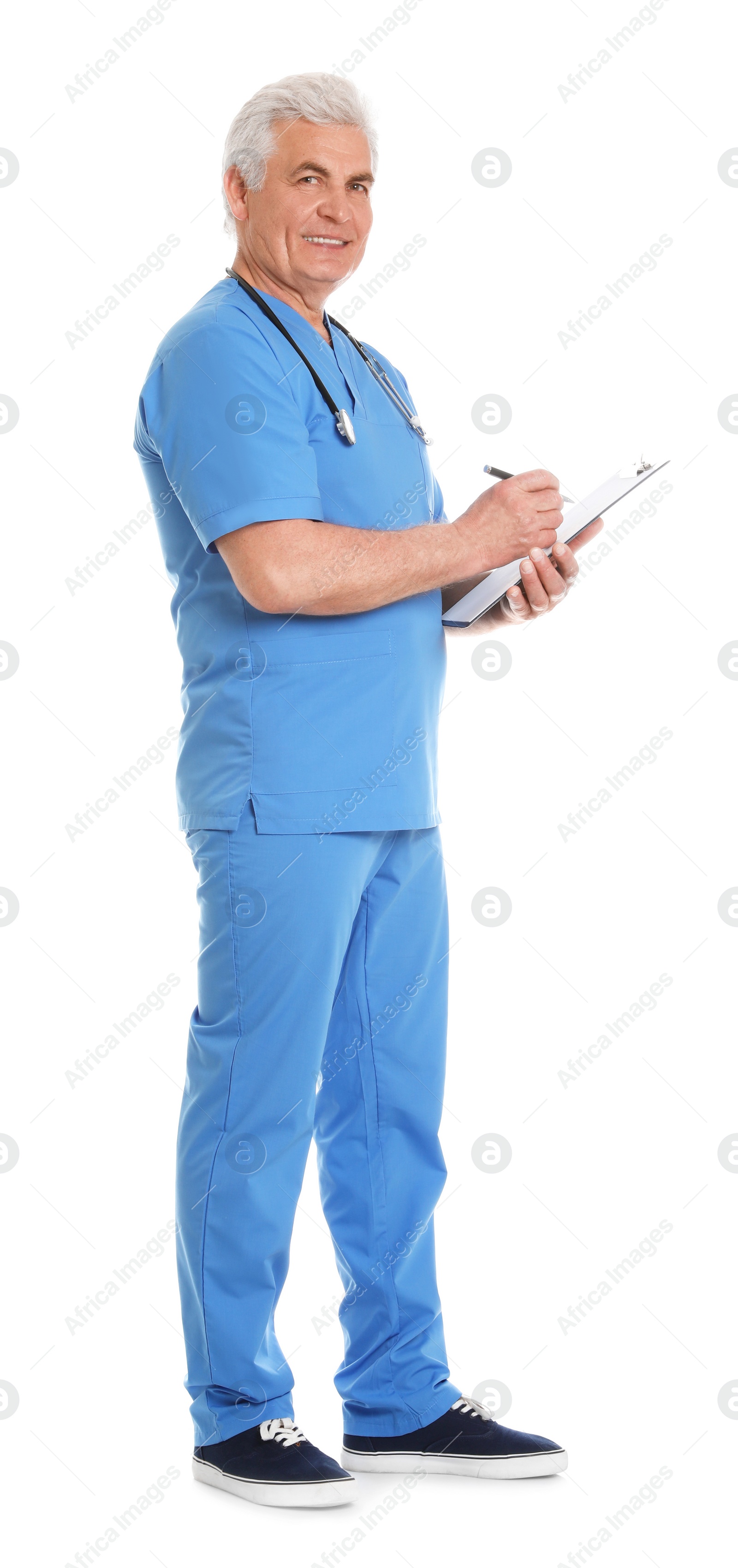 Photo of Full length portrait of male doctor in scrubs with clipboard isolated on white. Medical staff