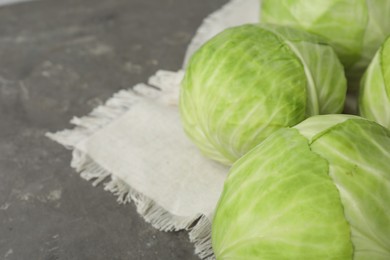 Photo of Ripe white cabbage on grey table, closeup. Space for text