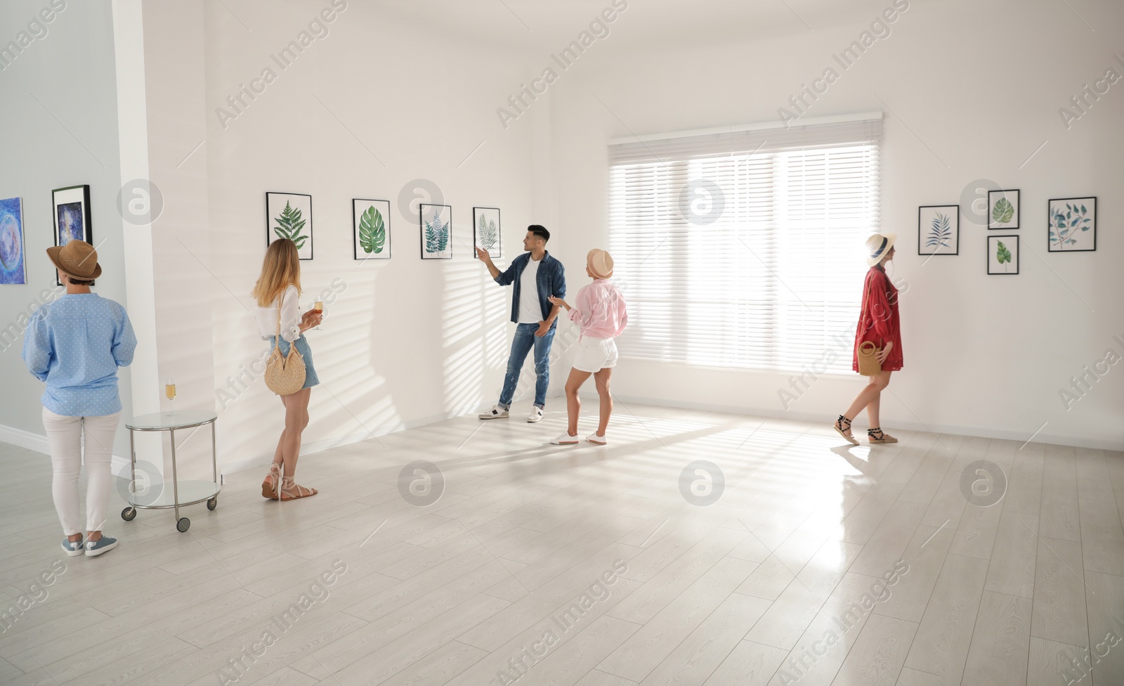 Photo of Group of people at exhibition in art gallery