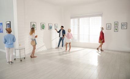 Photo of Group of people at exhibition in art gallery