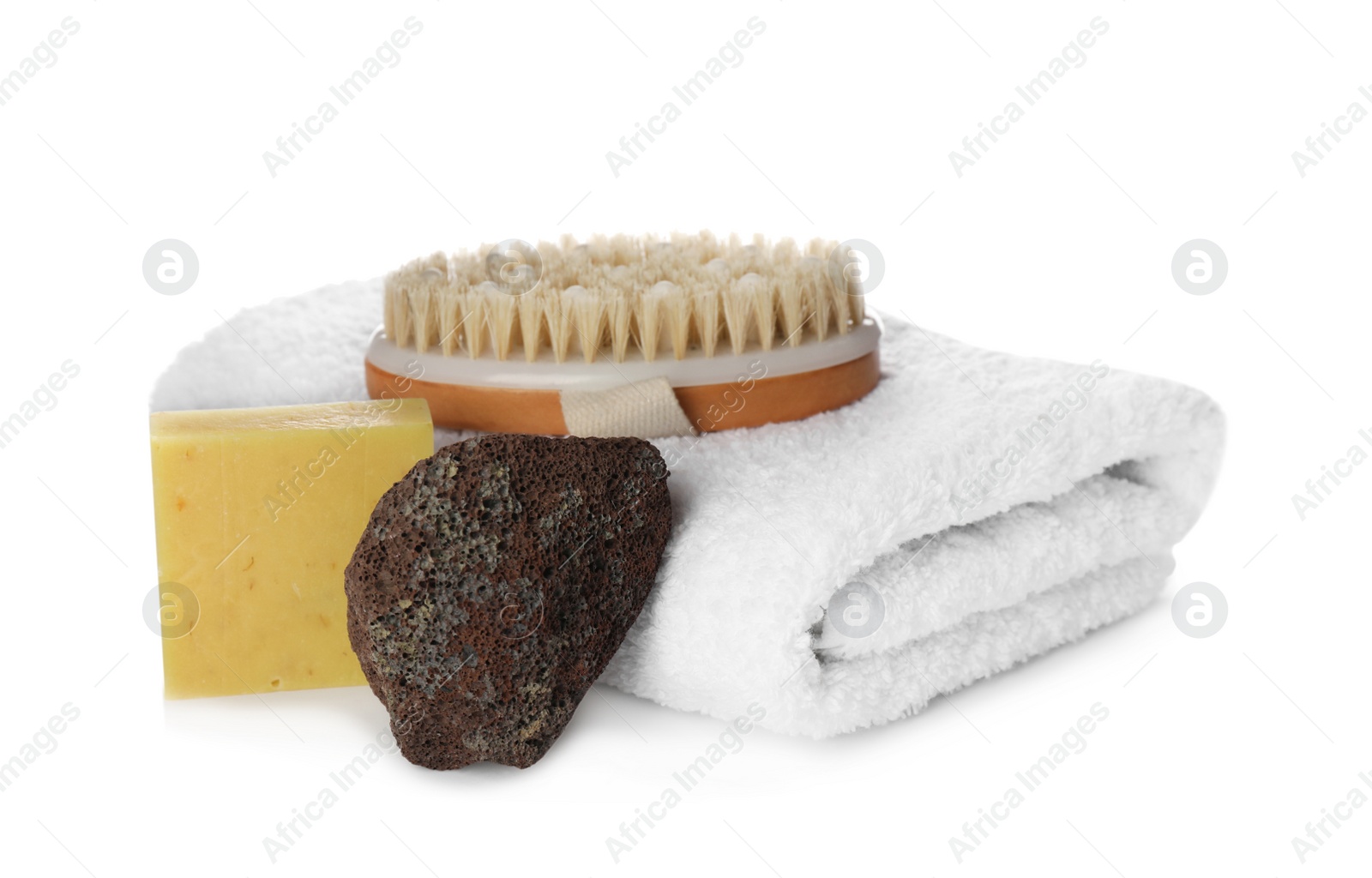 Photo of Pumice stone, towel, soap bar and brush on white background