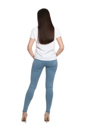 Photo of Woman wearing stylish light blue jeans on white background, back view