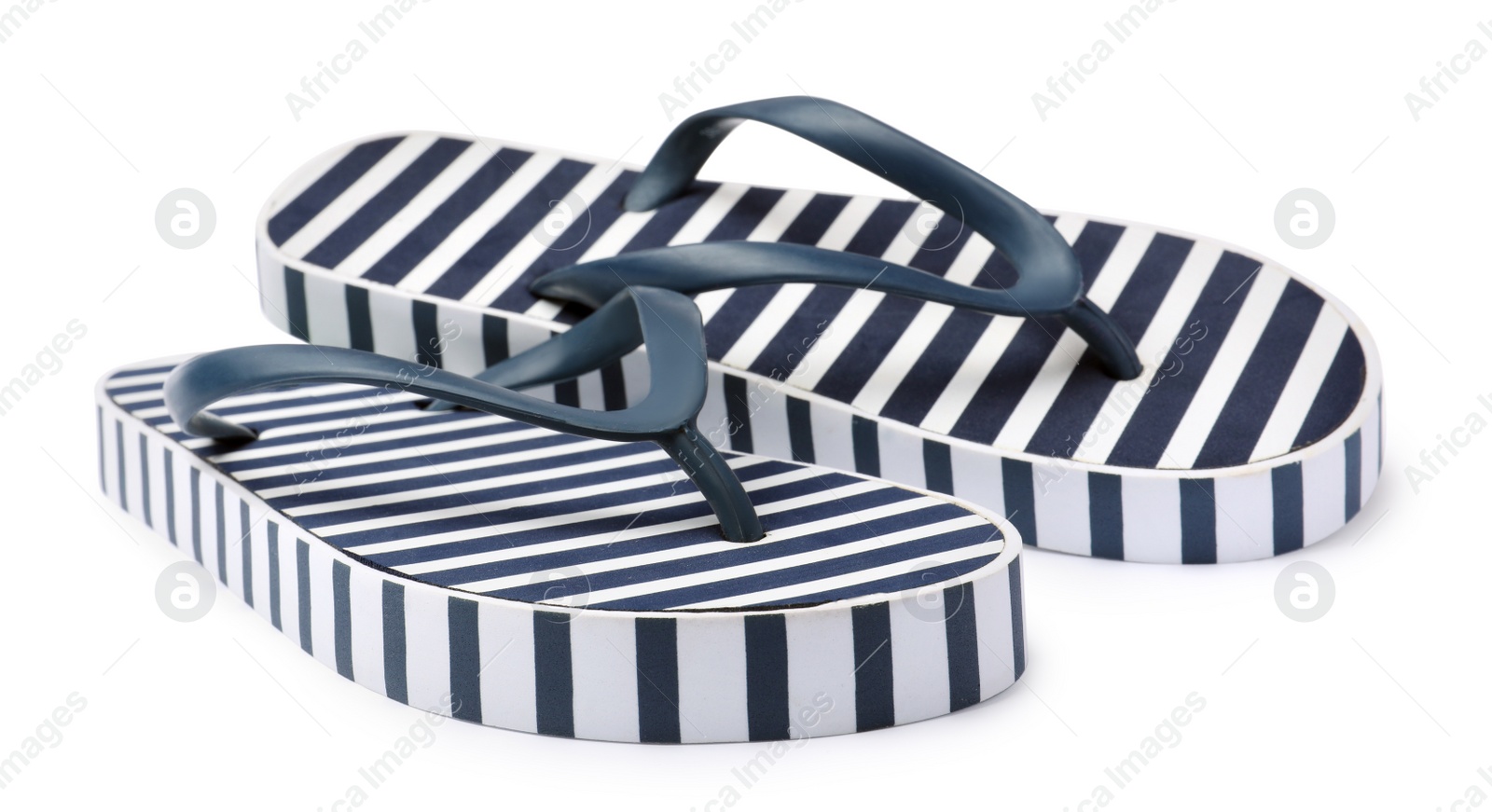 Photo of Pair of striped flip flops on white background