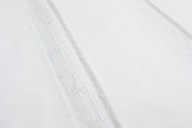 Car tire tracks on fresh snow, outdoors