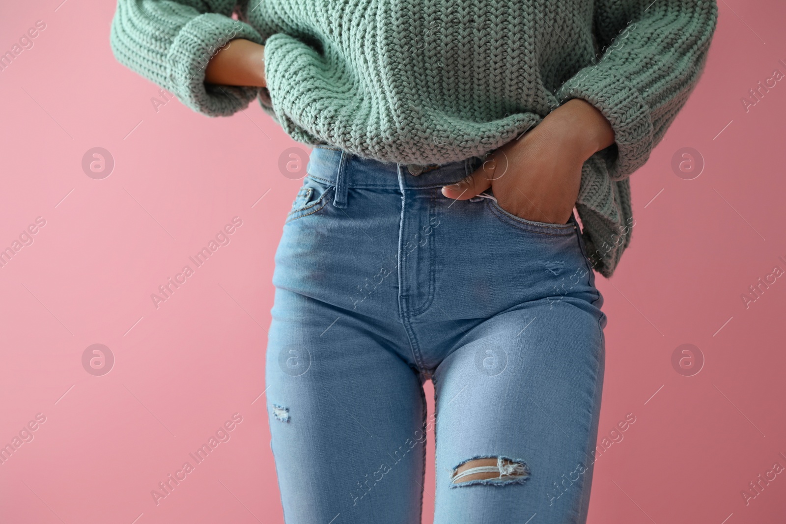 Photo of Woman wearing jeans on pink background, closeup