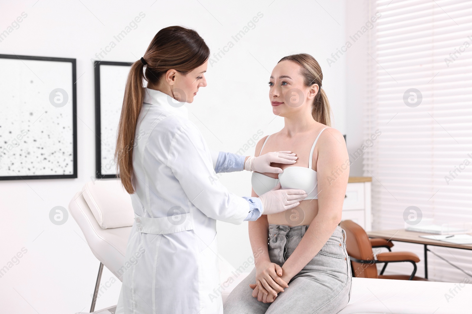 Photo of Mammologist checking young woman's breast in hospital