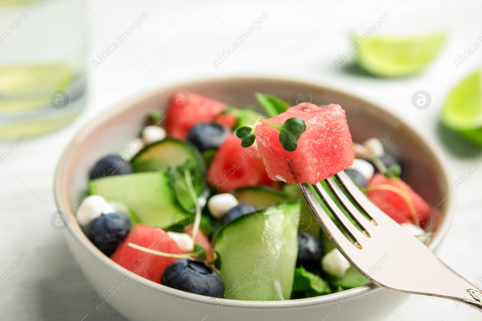 Photo of Delicious salad with watermelon served in bowl, closeup