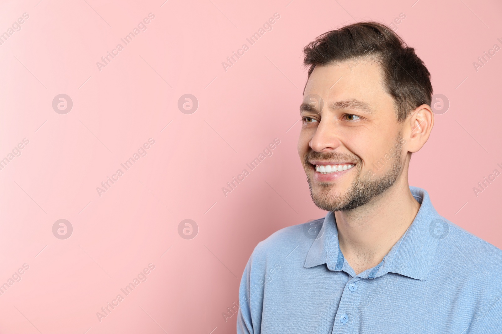 Photo of Smiling man with perfect teeth on color background. Space for text