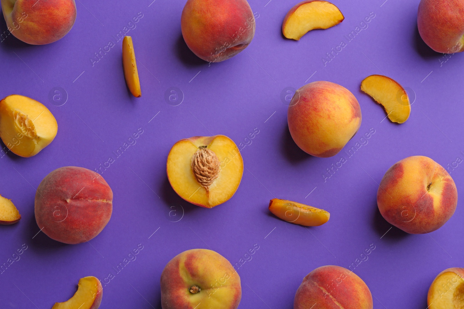 Photo of Flat lay composition with fresh peaches on purple background