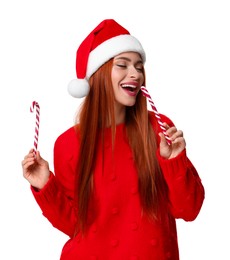 Young woman in red sweater and Santa hat with candy canes on white background. Christmas celebration