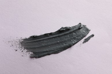 Photo of Sample of face mask on lilac background, top view