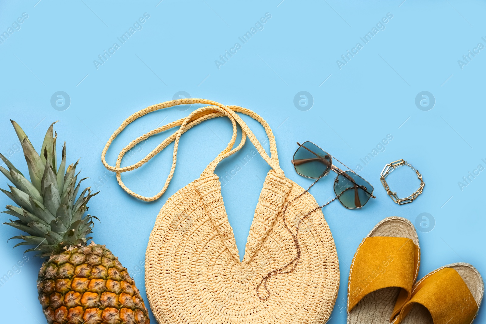 Photo of Flat lay composition with woman's straw bag on light blue background
